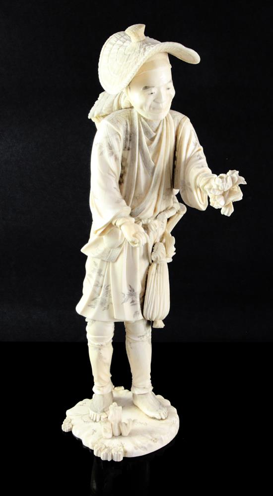 A large Japanese sectional ivory figure of a farmer, early 20th century, 36.5cm